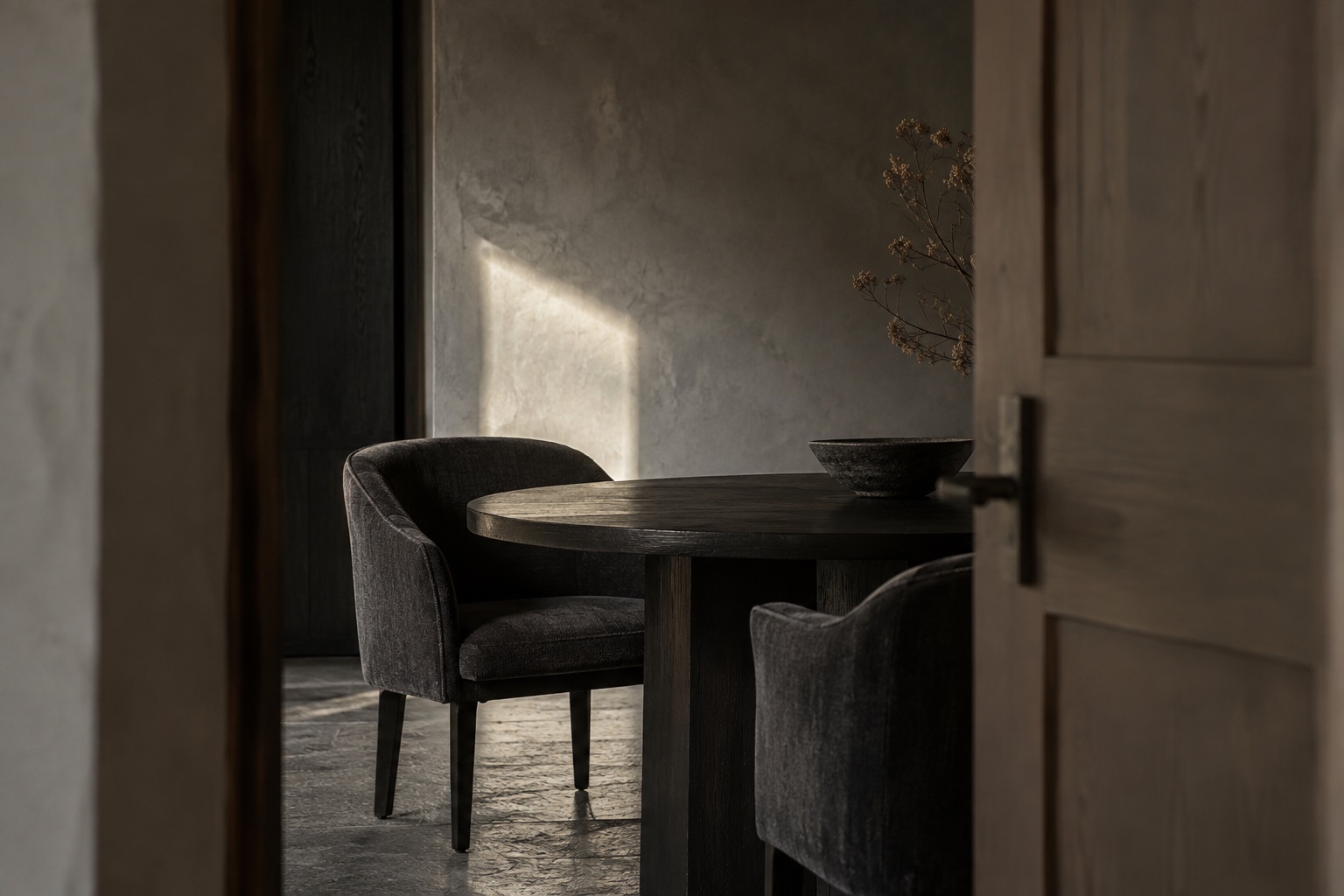 A quiet room with dark walls and soft window light.